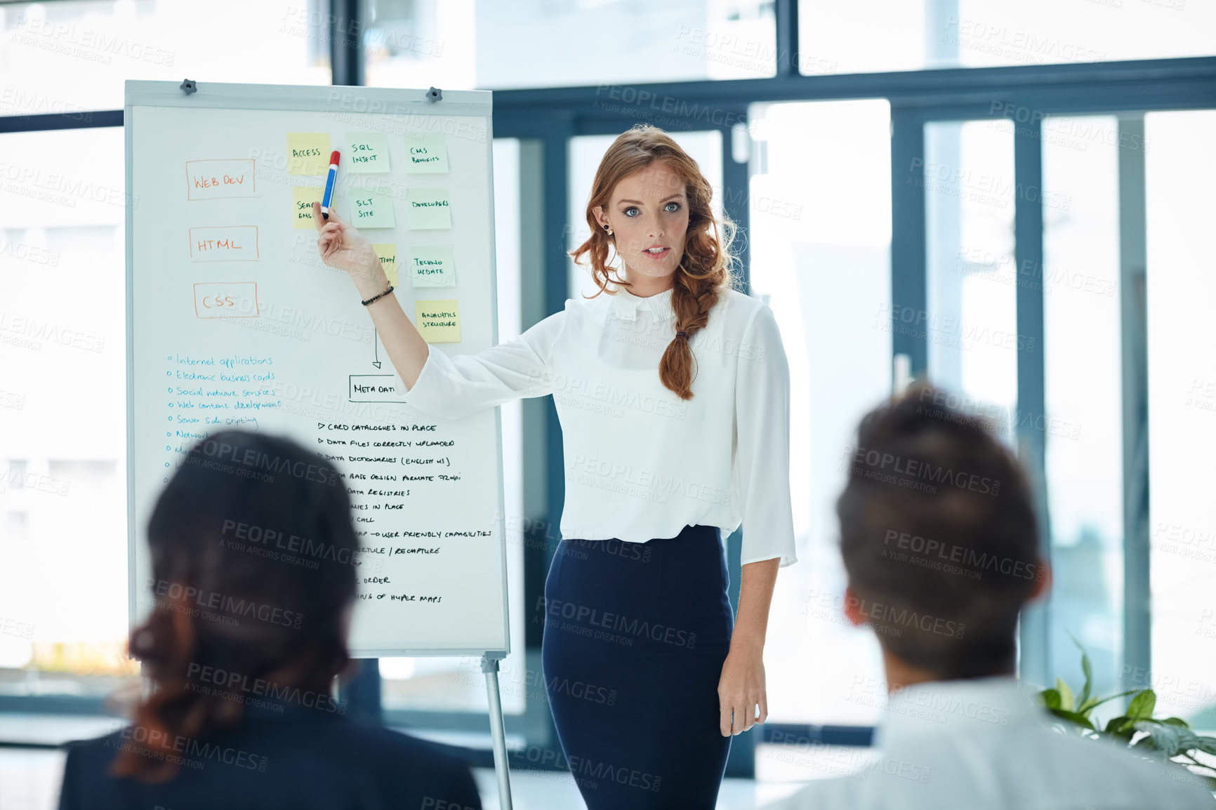 Buy stock photo Cropped shot of a young businesswoman giving a presentation to her colleagues in an office