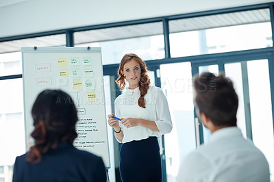 Buy stock photo Cropped shot of a young businesswoman giving a presentation to her colleagues in an office