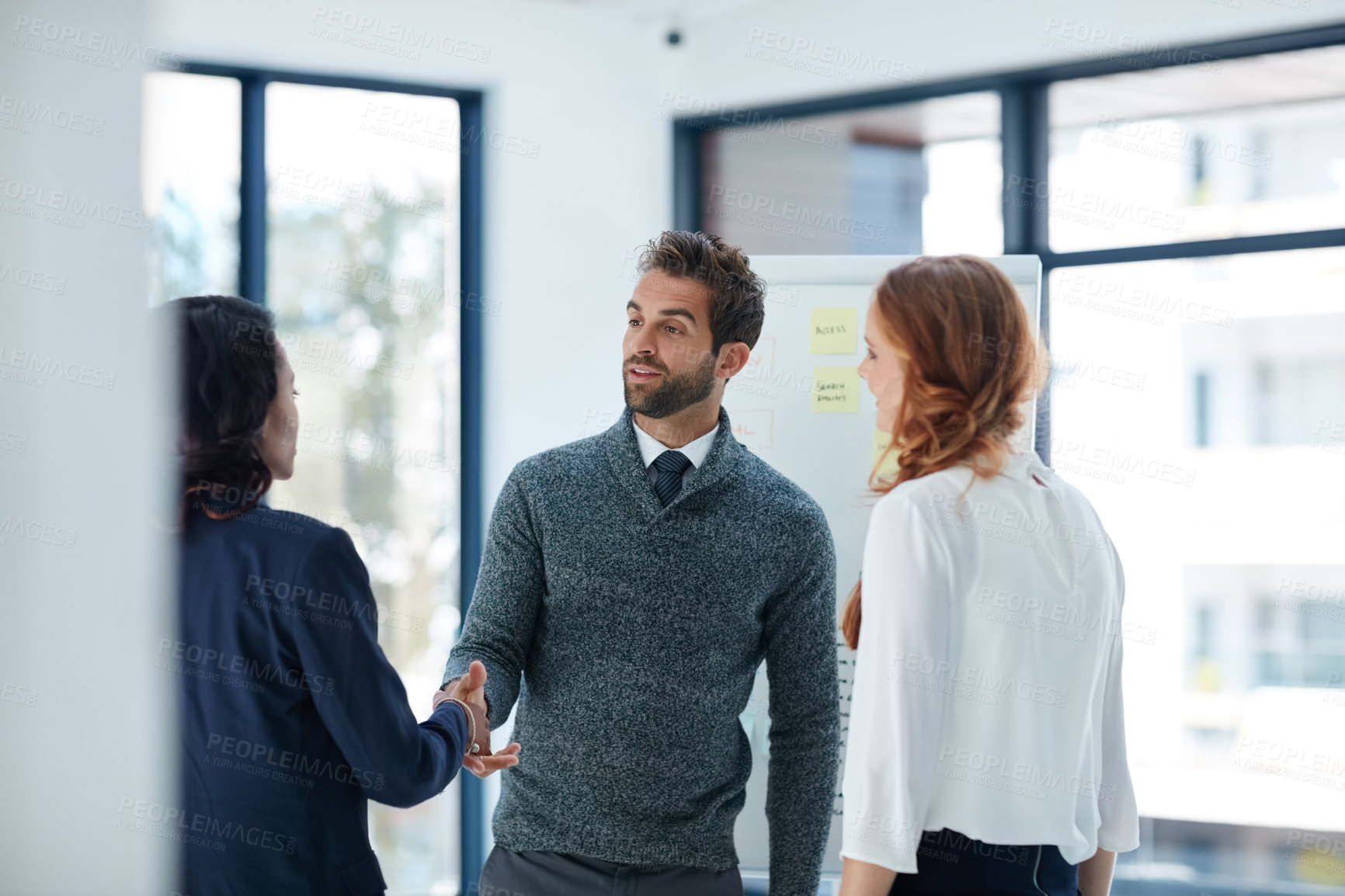 Buy stock photo Cropped shot of businesspeople shaking hands in an office