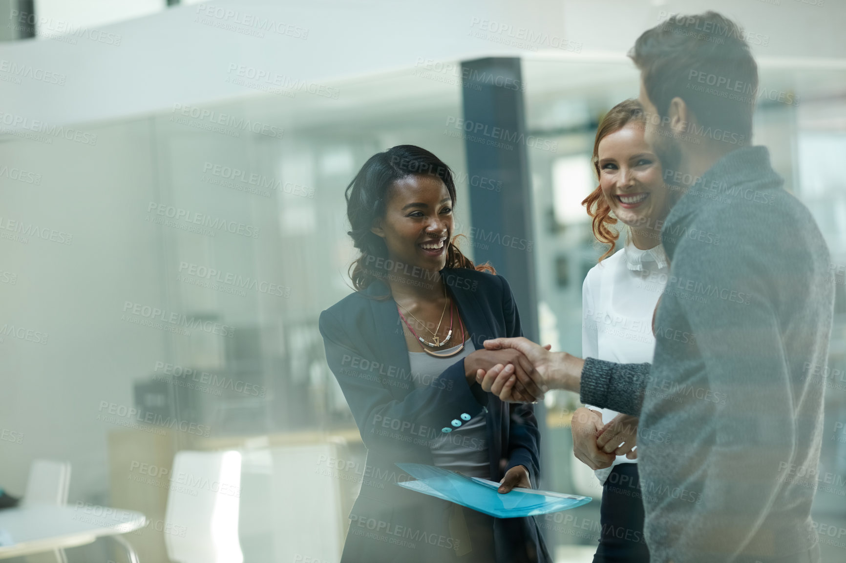 Buy stock photo Cropped shot of businesspeople shaking hands in an office