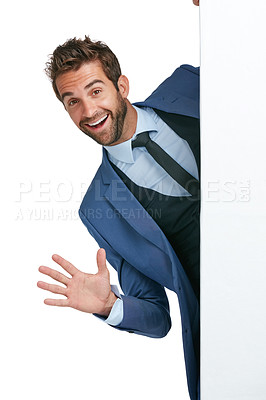 Buy stock photo Studio shot of a handsome businessman jumping out from behind a wall against a white background