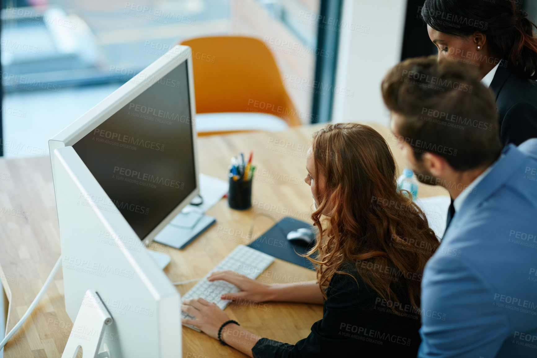 Buy stock photo Cropped shot of colleagues working together on a computer in an office