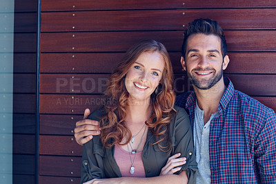 Buy stock photo Portrait of an affectionate young couple posing against a wooden wall together