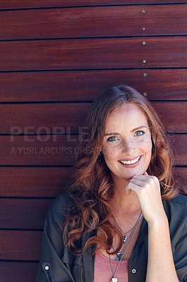 Buy stock photo Portrait of an attractive young woman posing against a wooden wall