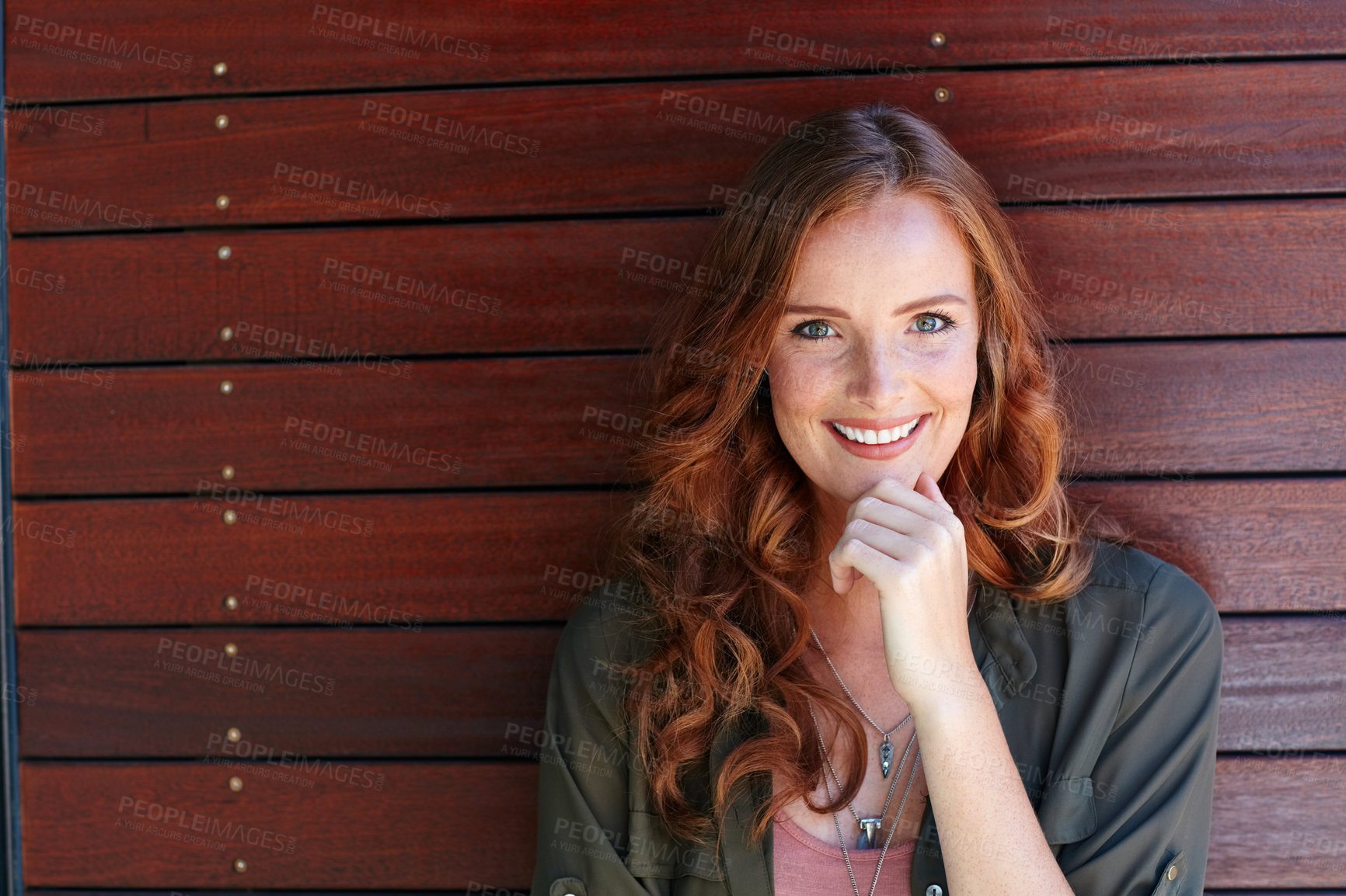 Buy stock photo Portrait of an attractive young woman posing against a wooden wall