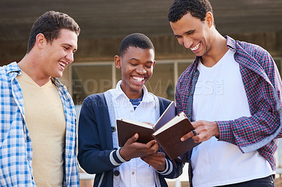 Buy stock photo Cropped shot of a group of university students looking through their notes together on campus