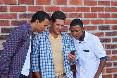 Buy stock photo Cropped shot of a group of university students hanging out between class