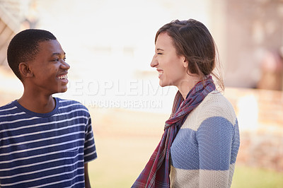Buy stock photo Cropped shot of two university students hanging out between class