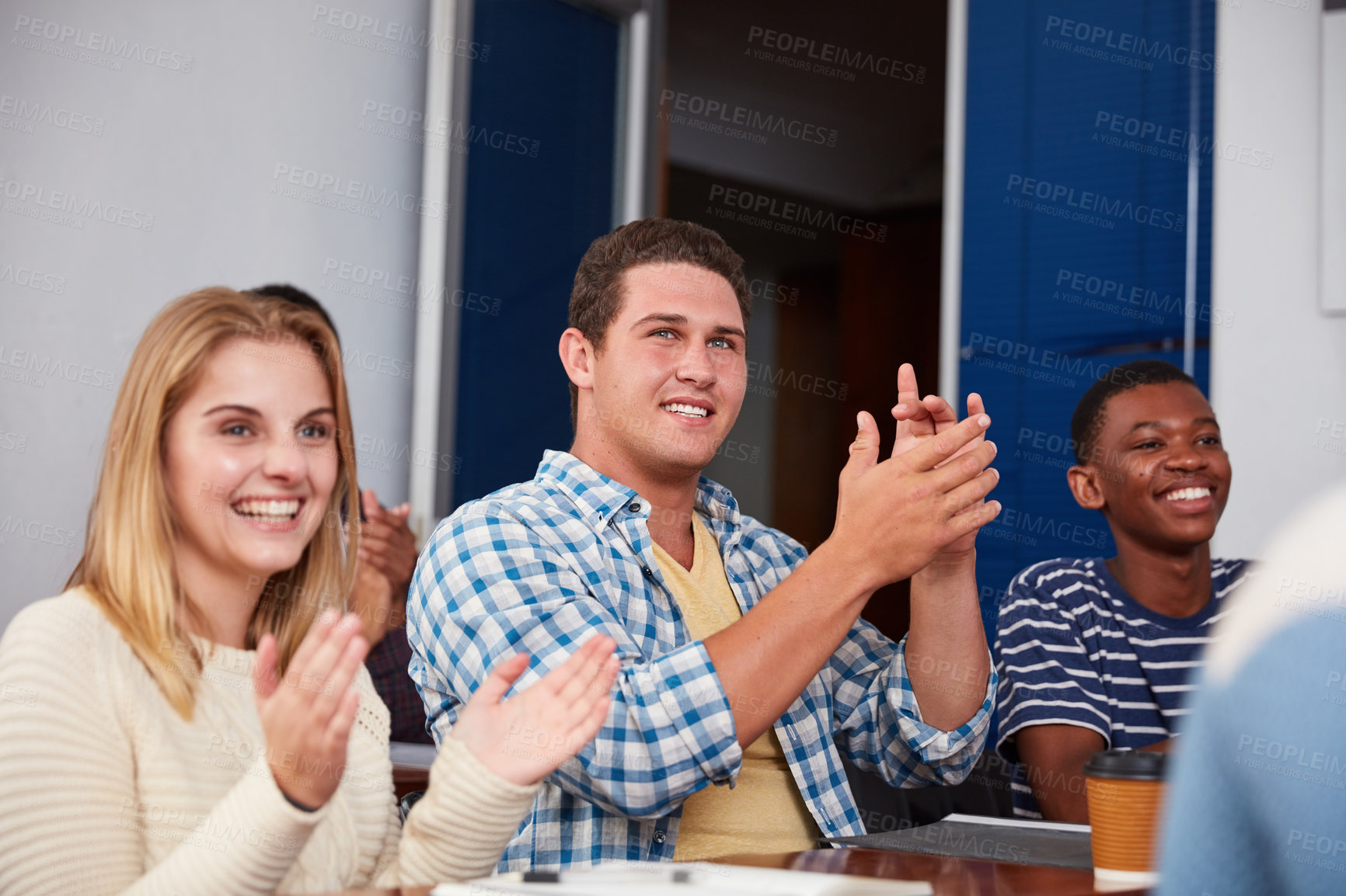 Buy stock photo Cropped shot of a group of university students applauding together in class