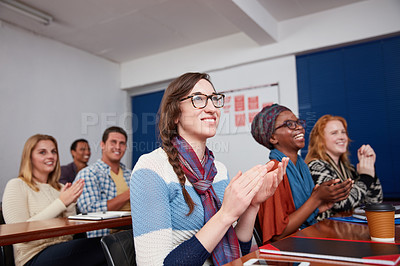 Buy stock photo Cropped shot of a group of university students applauding together in class