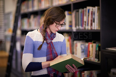 Buy stock photo Cropped shot of a university student working in the campus library