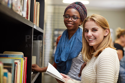 Buy stock photo Portrait of two university students working together in the campus library