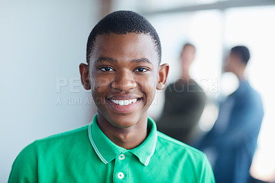 Buy stock photo Portrait of a young university student standing in his classroom