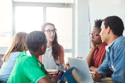 Buy stock photo Shot of a group of university students working on a group project in class