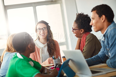 Buy stock photo Shot of a group of university students working on a group project in class