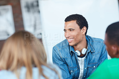 Buy stock photo Shot of a young university student sitting in his classroom during a group project