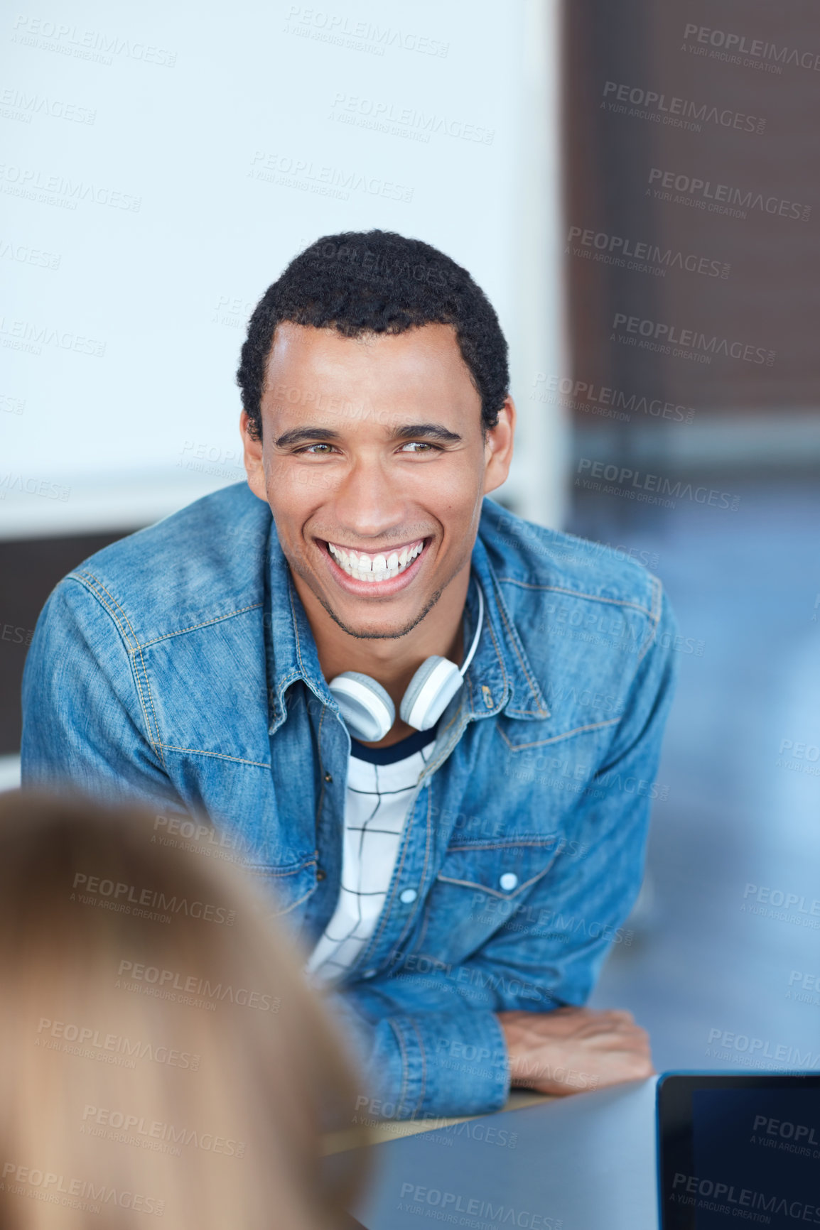 Buy stock photo Shot of a young university student sitting in his classroom during a group project