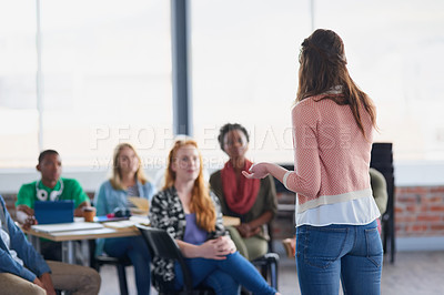 Buy stock photo Rearview shot of young university student addressing her class during a lesson