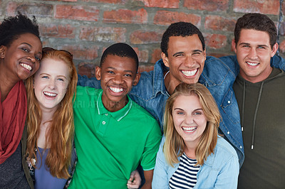 Buy stock photo Portrait of a group of university students standing in their university building