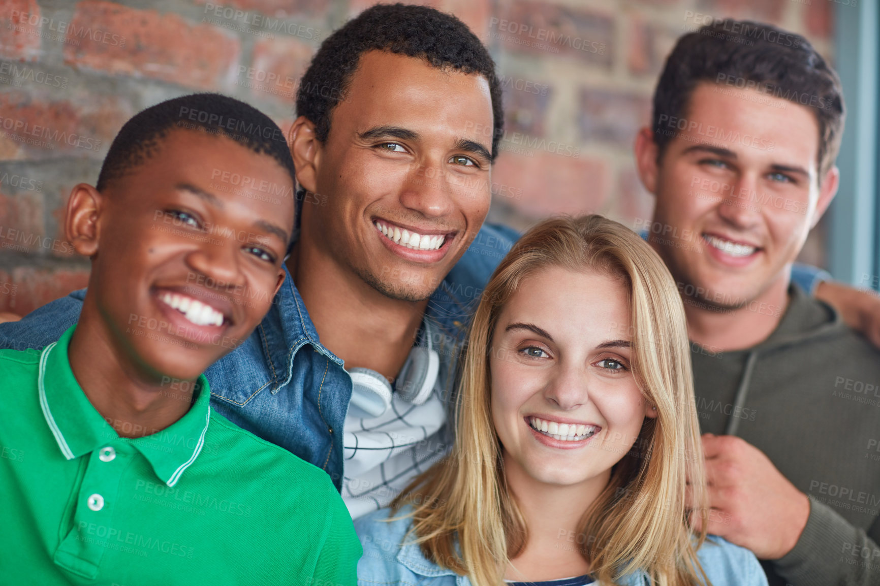 Buy stock photo Portrait of a group of university students standing in their university building