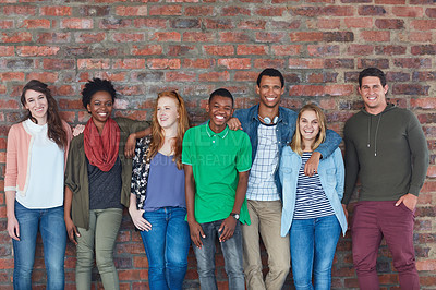 Buy stock photo Portrait of a group of university students standing in their university building