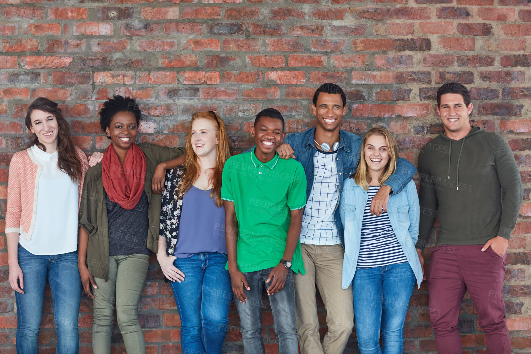 Buy stock photo Portrait of a group of university students standing in their university building