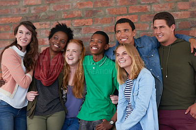 Buy stock photo Shot of a group of university students standing in their university building