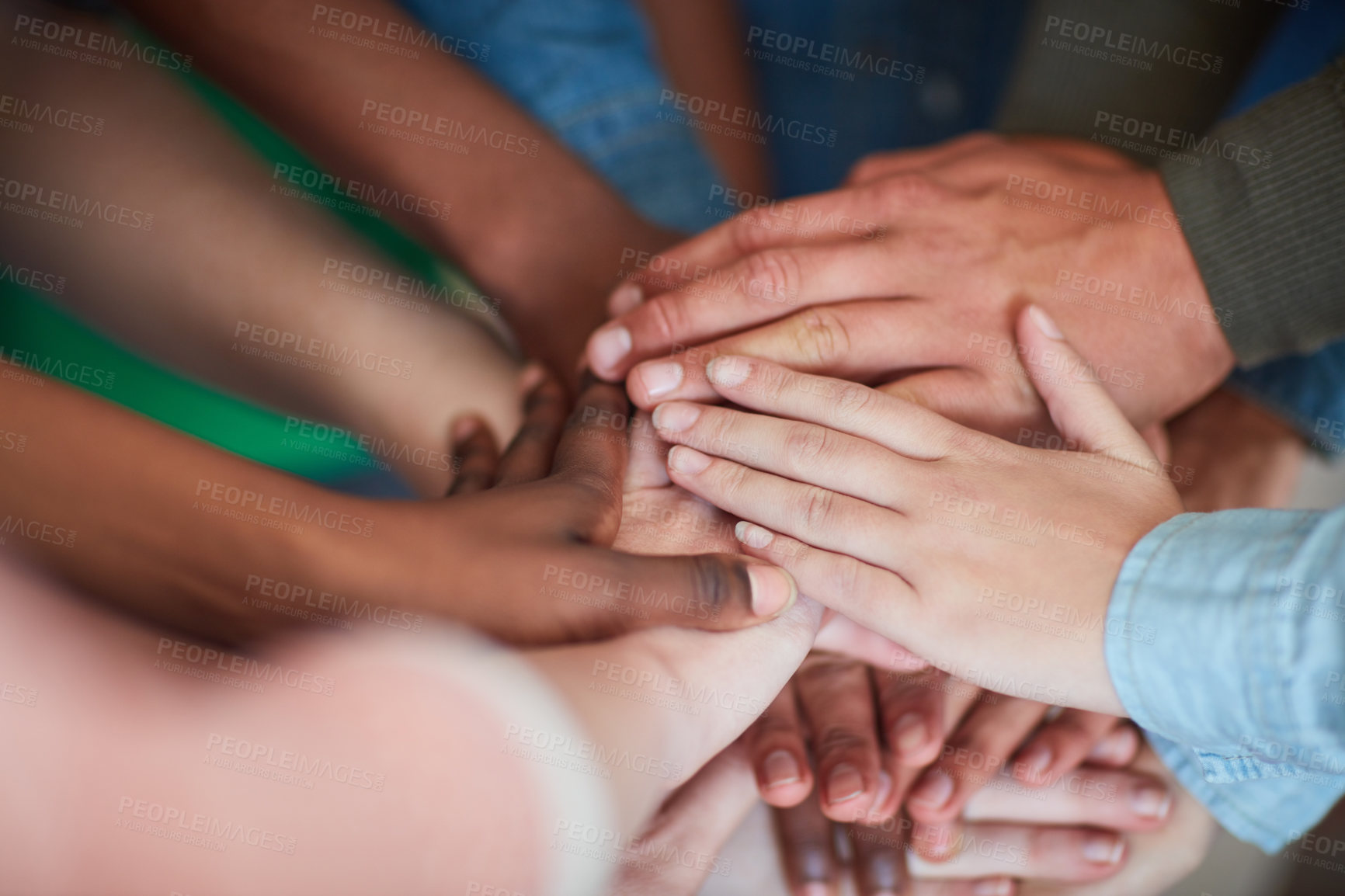 Buy stock photo High angle shot of university students' hands in a huddle