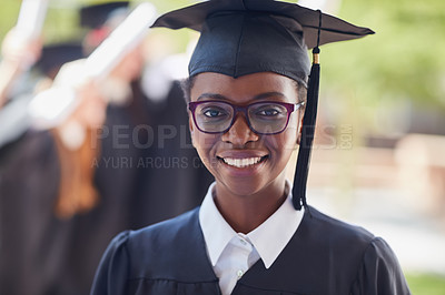Buy stock photo Portrait of a happy female student standing outside on her graduation day