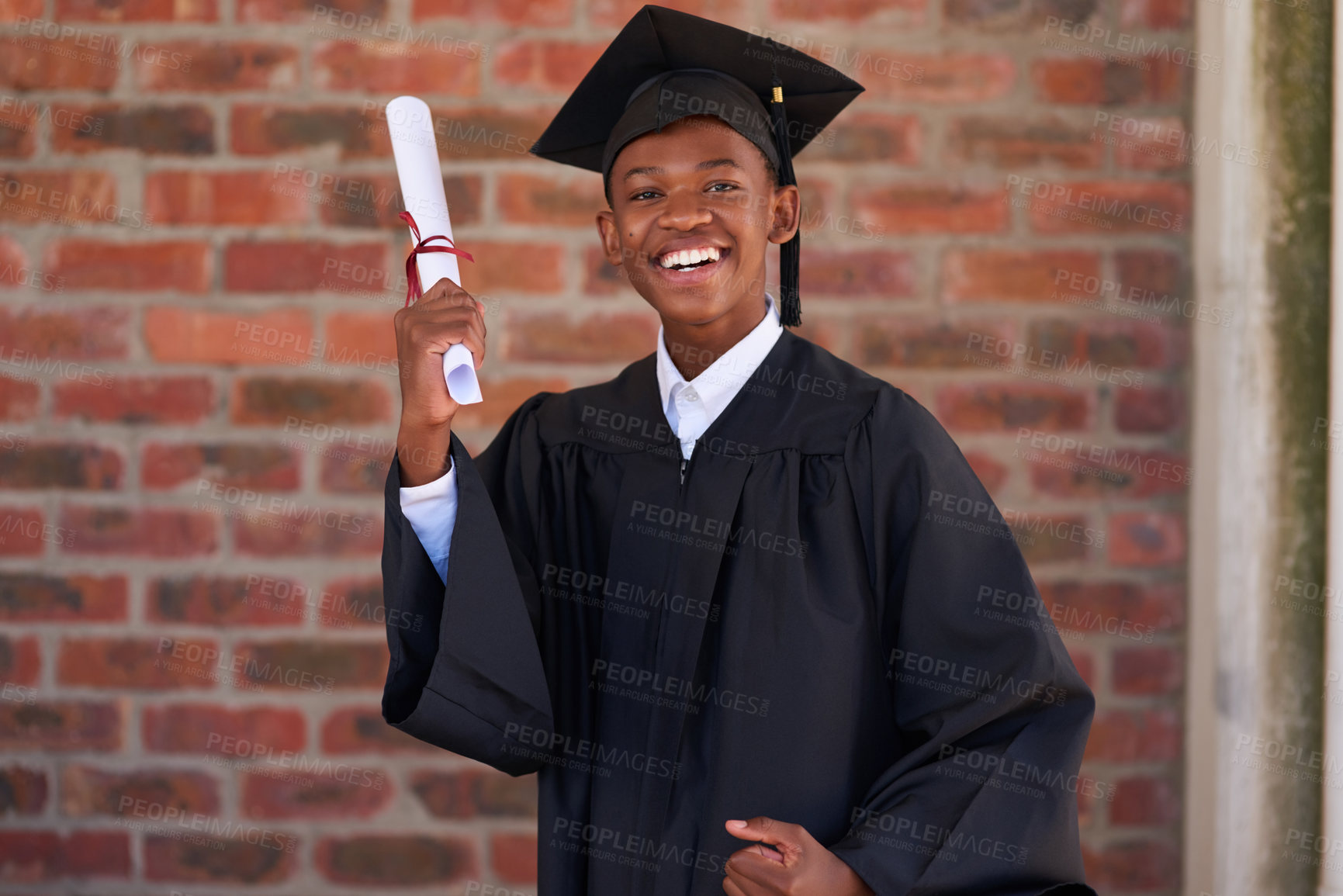 Buy stock photo Portrait of a happy male student standing with his diploma on graduation day