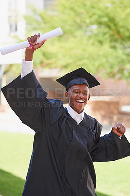 Buy stock photo Shot of a happy male student celbrating with his diploma on graduation day