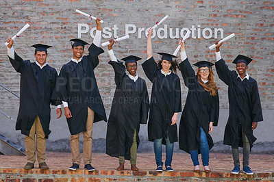 Buy stock photo Portrait of a happy group of students standing with their diplomas on graduation day