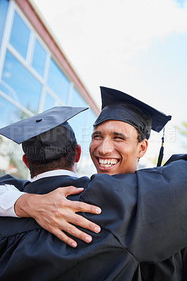 Buy stock photo Shot of two female students congratulating each other on graduation day