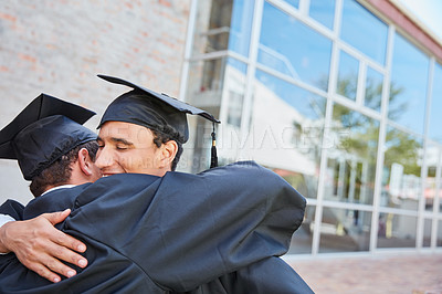 Buy stock photo Shot of two male students congratulating each other on graduation day