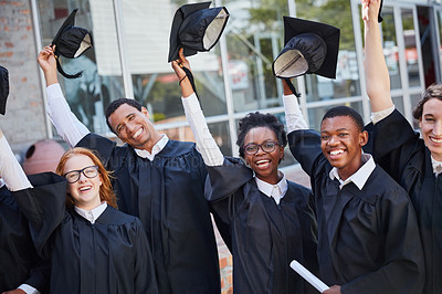 Buy stock photo Portrait of a happy group of students standing outside on their graduation day