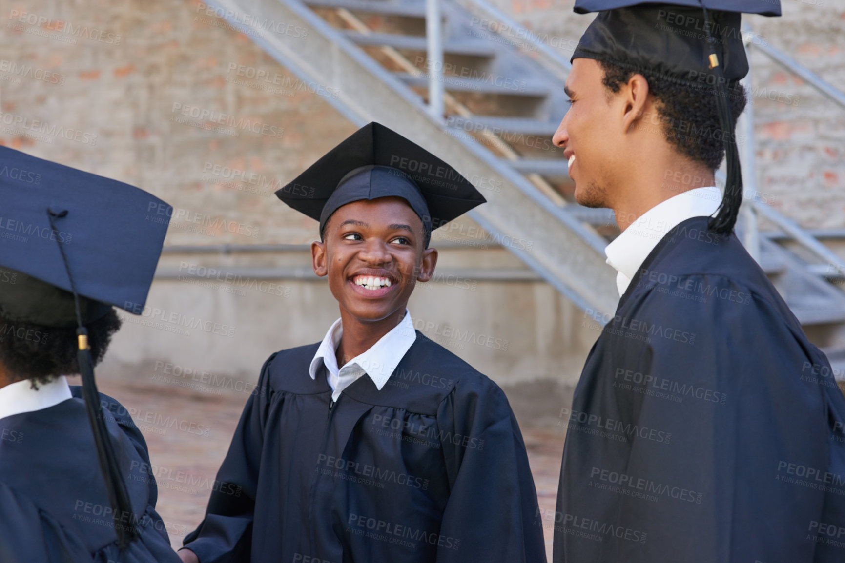 Buy stock photo Shot of a happy group of students standing outside on their graduation day