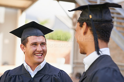 Buy stock photo Shot of two male students talking each other on graduation day
