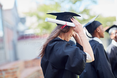 Buy stock photo Shot of a happy group of students standing outside on their graduation day