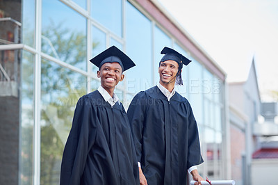 Buy stock photo Shot of a two male students standing outside on their graduation day