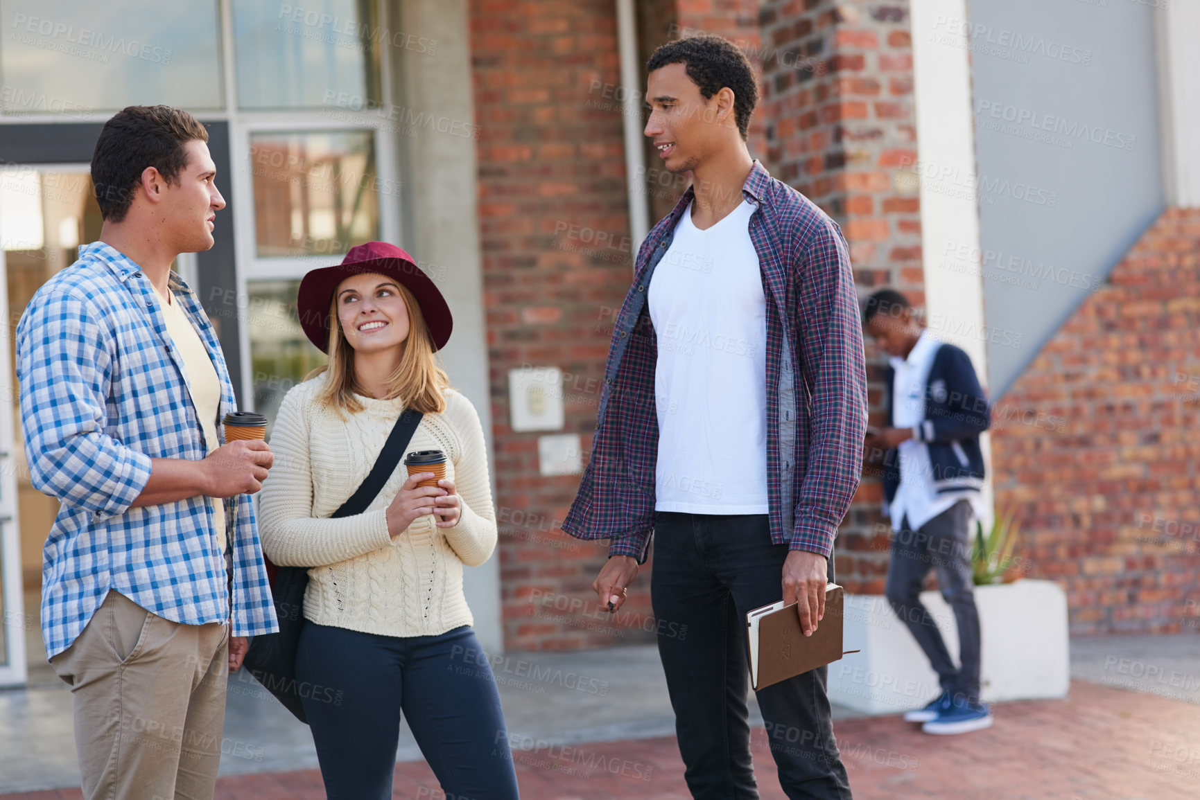 Buy stock photo Cropped shot of a group of university students hanging out between class