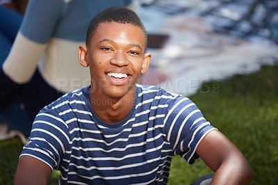 Buy stock photo Cropped portrait of a happy young man relaxing outside on campus