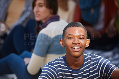 Buy stock photo Cropped portrait of a happy young man relaxing outside on campus