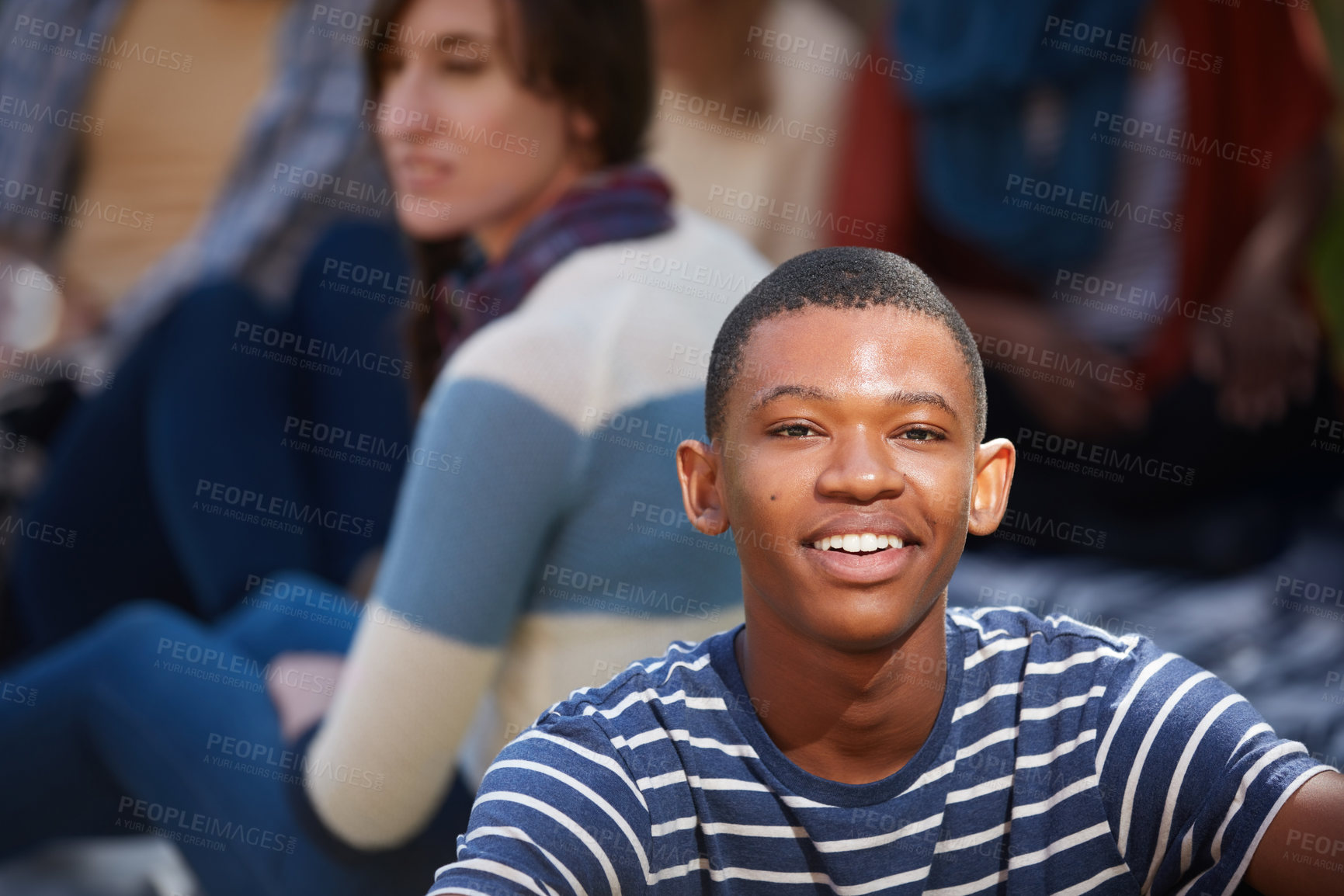 Buy stock photo Cropped portrait of a happy young man relaxing outside on campus