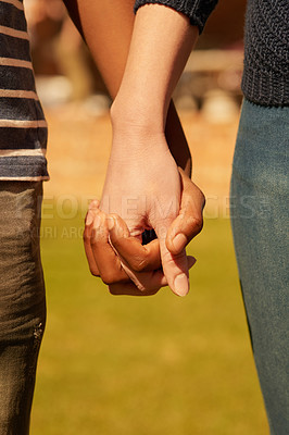 Buy stock photo Cropped shot of a couple holding hands