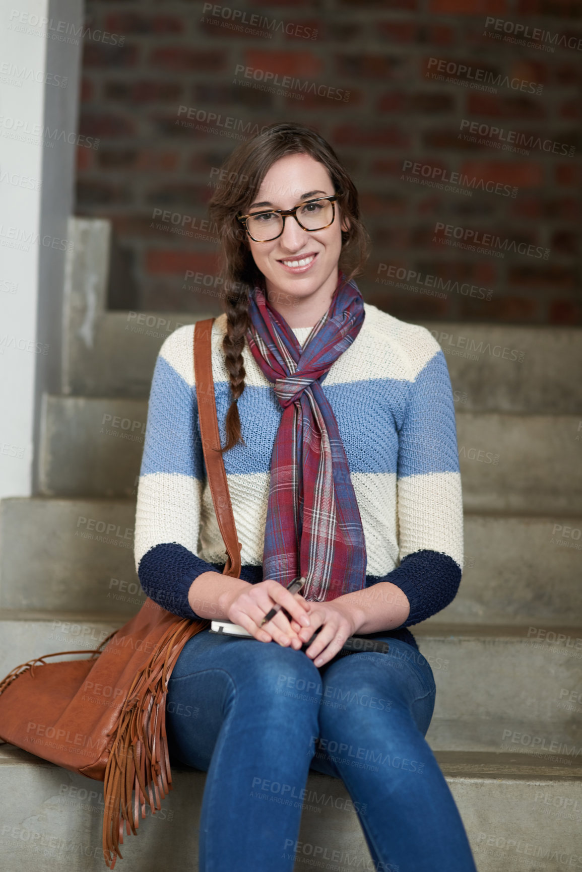 Buy stock photo Portrait of a university student sitting on a staircase at campus