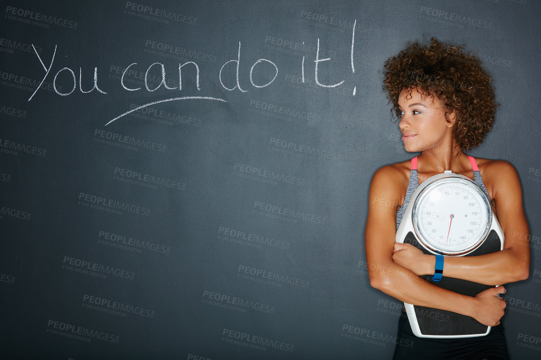 Buy stock photo Shot of a woman holding a scale against a chalk background with a motivational message