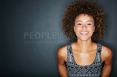 Buy stock photo Studio shot of a happy woman posing against a dark background