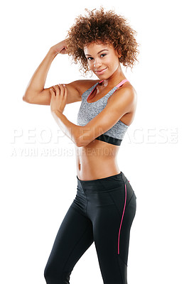 Buy stock photo Studio shot of a fit young woman flexing her muscles against a white background