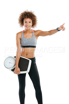 Buy stock photo Studio portrait of a fit young woman holding a scale against a white background