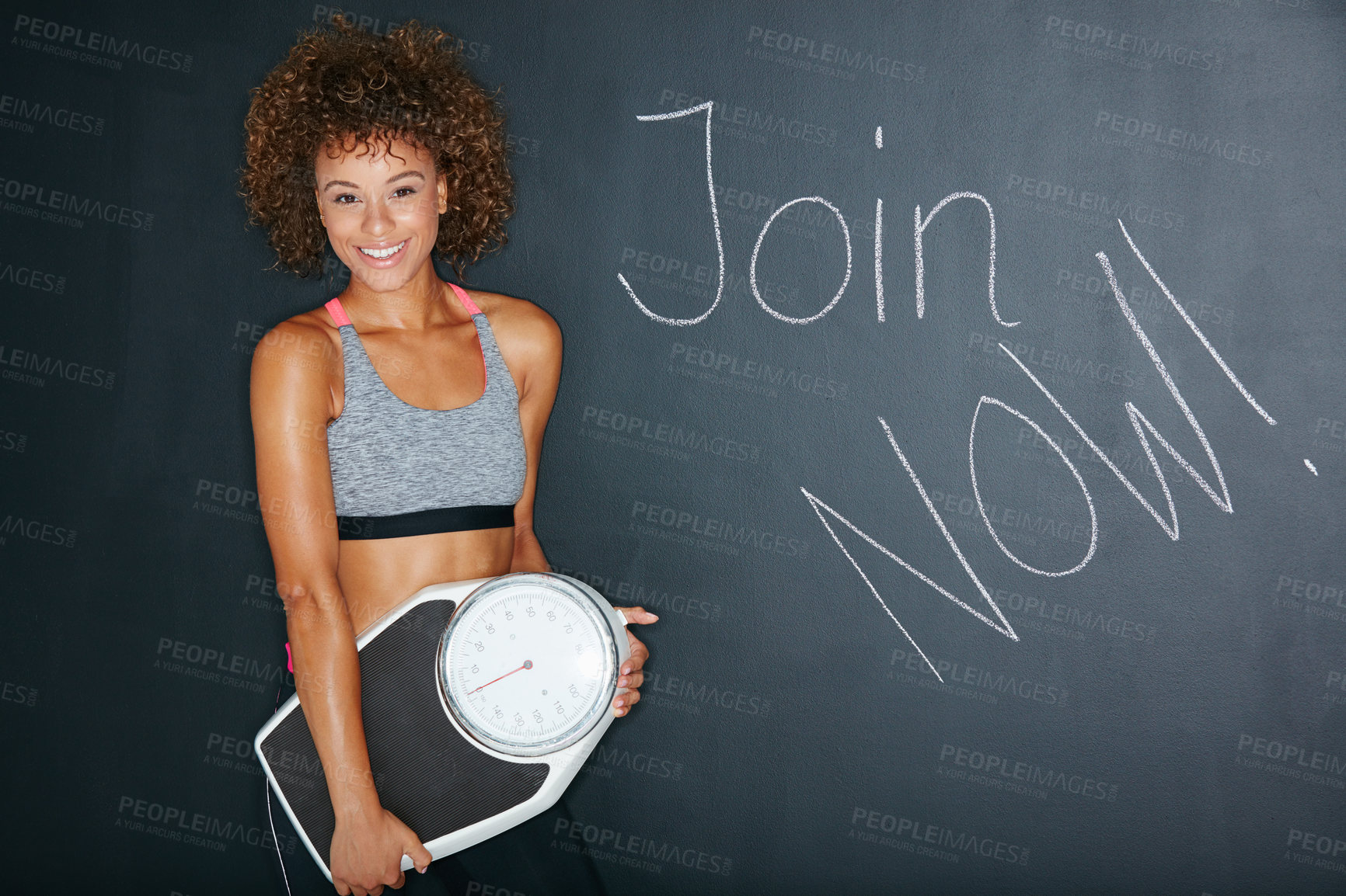 Buy stock photo Shot of a woman holding a scale against a chalk background with a message